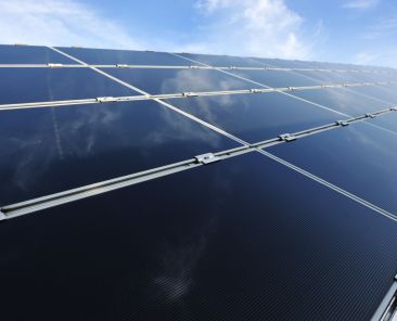 Alternative energy photovoltaic solar panels against blue sky