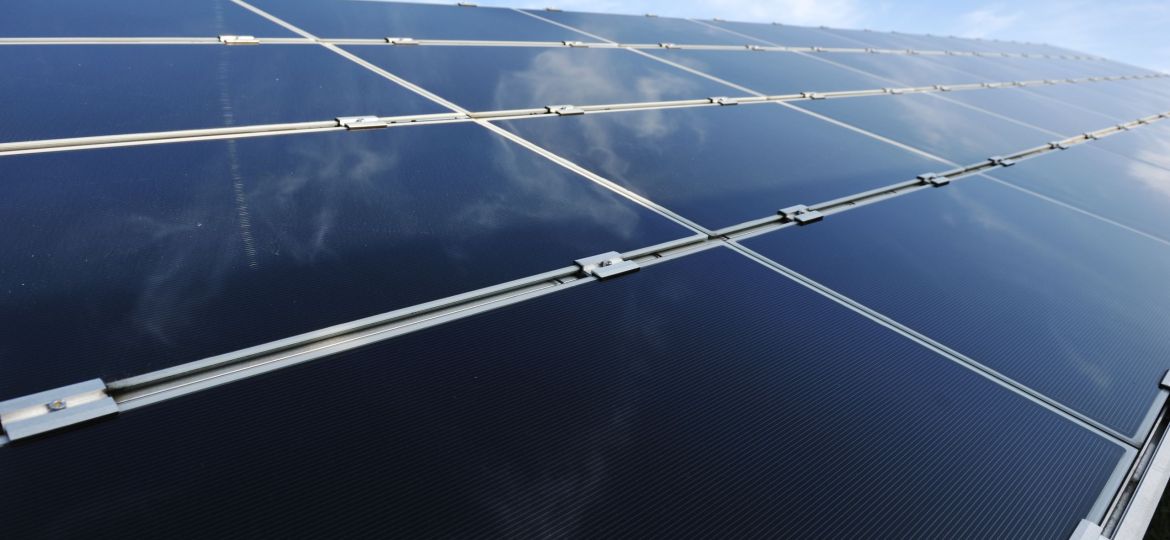 Alternative energy photovoltaic solar panels against blue sky